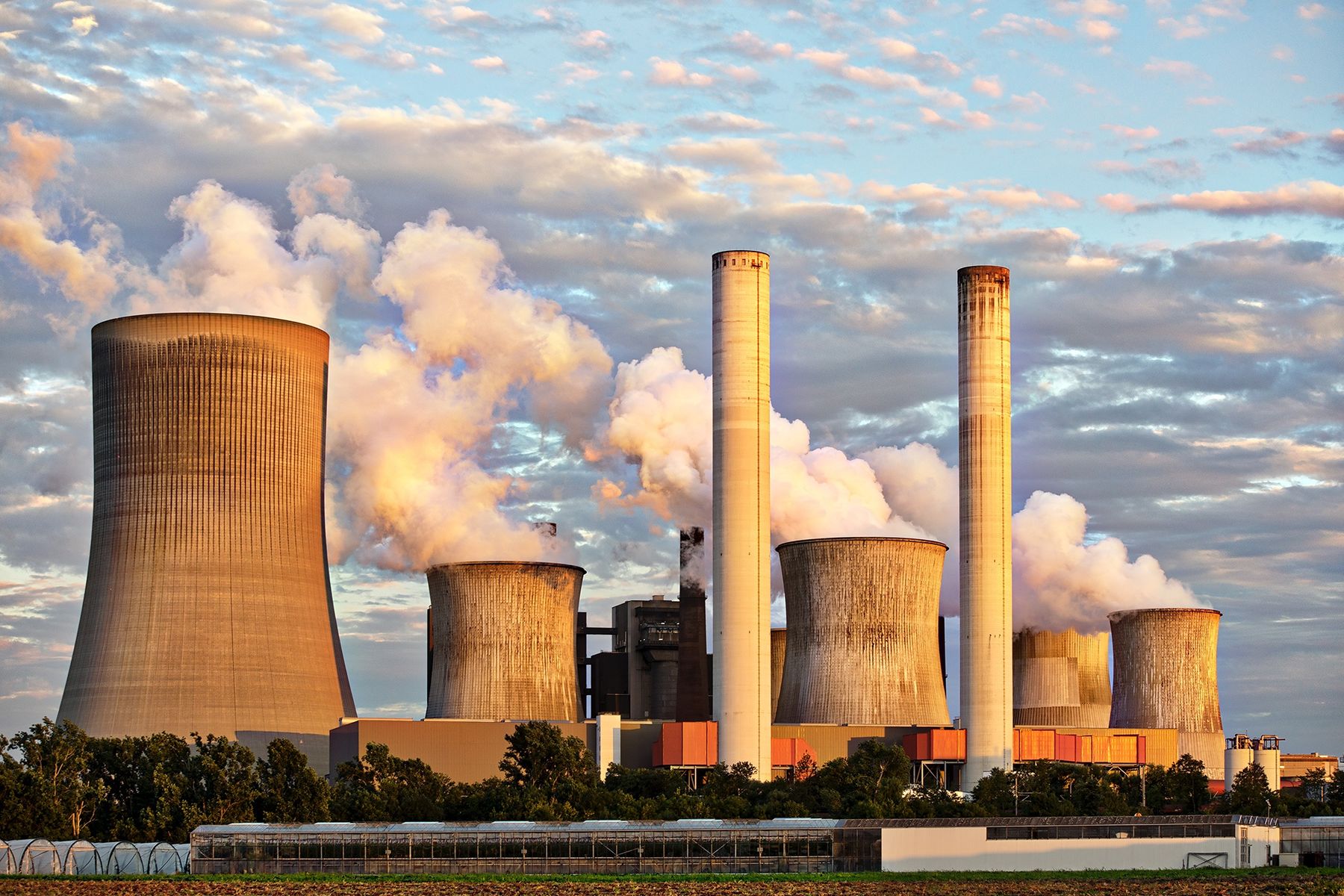 Power generation plant with cooling towers at sunset